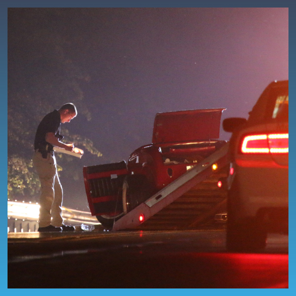 man inspecting car crash