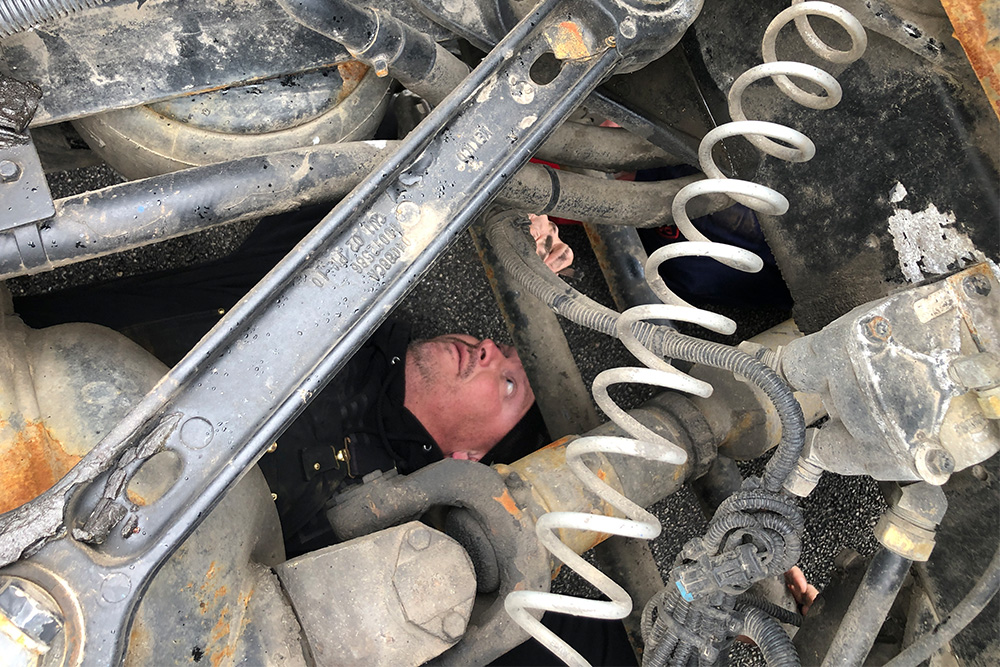 Man inspecting heavy vehicle brake system