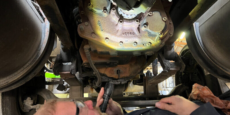 Accident reconstruction expert inspecting real-world evidence.